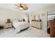 Bright bedroom with white tile flooring, ceiling fan, and furniture, creating a comfortable and stylish retreat at 11318 Stoneybrook Path, Port Richey, FL 34668