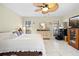 Spacious bedroom with tile floors, neutral walls, a ceiling fan, and large windows, ensuring a bright and airy feel at 11318 Stoneybrook Path, Port Richey, FL 34668