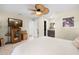 Bright main bedroom features a ceiling fan, television, and ensuite bathroom for comfortable living at 11318 Stoneybrook Path, Port Richey, FL 34668
