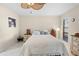 Inviting bedroom with white tile floor, ceiling fan, and natural light, providing a cozy and serene space at 11318 Stoneybrook Path, Port Richey, FL 34668