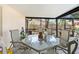 Covered patio with comfortable seating, perfect for outdoor dining and relaxation in the backyard at 11318 Stoneybrook Path, Port Richey, FL 34668