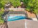 Aerial view of a screened-in backyard pool, enclosed by a wooden fence and lush foliage at 11318 Stoneybrook Path, Port Richey, FL 34668