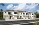 New townhomes featuring attached garages, neutral color schemes, stone accents and lush landscaping at 11408 Velvet Apricot Dr, Land O Lakes, FL 34638