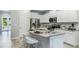Modern eat-in kitchen with stainless appliances, granite counters and bright white cabinetry at 11408 Velvet Apricot Dr, Land O Lakes, FL 34638