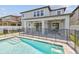Backyard featuring pool with black safety fence and covered patio at 11416 Alachua Creek Ln, Riverview, FL 33579
