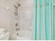 Bathroom featuring a shower and tub combo with patterned tile and a decorative shower curtain at 11416 Alachua Creek Ln, Riverview, FL 33579