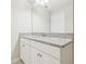 Bathroom with a white vanity, granite countertop, and a large mirror at 11416 Alachua Creek Ln, Riverview, FL 33579