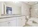 Bright bathroom with granite countertop, white vanity, and shower and tub combo at 11416 Alachua Creek Ln, Riverview, FL 33579