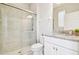 Bathroom featuring tile shower, granite countertop, and updated fixtures at 11416 Alachua Creek Ln, Riverview, FL 33579