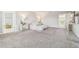 Large bedroom with a king bed, mirrored nightstands, and neutral carpet at 11416 Alachua Creek Ln, Riverview, FL 33579
