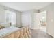 Bedroom features a bed and an open door to the living room at 11416 Alachua Creek Ln, Riverview, FL 33579