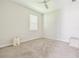 A bright and empty bedroom with neutral colored walls and carpet with minimal decoration at 11416 Alachua Creek Ln, Riverview, FL 33579