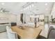 Open-concept dining area features a stylish chandelier and transitions into a modern kitchen at 11416 Alachua Creek Ln, Riverview, FL 33579