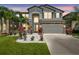 Two-story home with a two-car garage, stone accents and vibrant landscaping at 11416 Alachua Creek Ln, Riverview, FL 33579