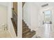 Grand foyer showcasing elegant staircase with wrought iron railing at 11416 Alachua Creek Ln, Riverview, FL 33579