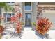The home's entryway features a glass paneled front door, stone accents, and decorative landscaping at 11416 Alachua Creek Ln, Riverview, FL 33579