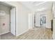 Bright hallway features white doors and light wood floors, creating a clean and modern look at 11416 Alachua Creek Ln, Riverview, FL 33579
