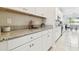 Kitchen counter with granite countertops, white cabinets, and stainless steel appliances at 11416 Alachua Creek Ln, Riverview, FL 33579