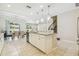 Open concept kitchen featuring stainless appliances, a center island, and a tile backsplash at 11416 Alachua Creek Ln, Riverview, FL 33579