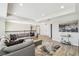 Bright living room features a sectional couch, decorative pillows, and a modern rug, creating an inviting space at 11416 Alachua Creek Ln, Riverview, FL 33579