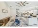 Open-concept living area featuring a large sectional sofa, a ceiling fan and stairs leading up at 11416 Alachua Creek Ln, Riverview, FL 33579