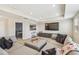 Spacious living room with large sectional couch, recessed lighting, and television at 11416 Alachua Creek Ln, Riverview, FL 33579