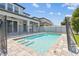 Backyard featuring a pool with black safety fence and covered patio at 11416 Alachua Creek Ln, Riverview, FL 33579
