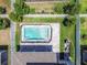 Aerial view of the rectangular pool featuring a safety fence and a paved patio in a private backyard at 11416 Alachua Creek Ln, Riverview, FL 33579