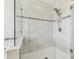 Close-up of shower featuring decorative tile, niche and rainfall shower head at 11416 Alachua Creek Ln, Riverview, FL 33579