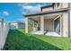 The large backyard features a covered patio, built-in grill, and is perfect for relaxing or entertaining at 11525 Scarlet Ibis Pl, Riverview, FL 33569