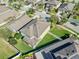 Aerial view showcases a landscaped backyard with lush green grass and perimeter fencing at 11525 Scarlet Ibis Pl, Riverview, FL 33569