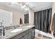 Bathroom featuring dual sinks, granite countertops, and a shower with black curtain at 11525 Scarlet Ibis Pl, Riverview, FL 33569