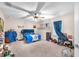 Bedroom featuring a ceiling fan, carpet flooring, and window with blue curtains at 11525 Scarlet Ibis Pl, Riverview, FL 33569