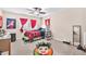 Bedroom with large windows and red curtains, ceiling fan, and themed rug at 11525 Scarlet Ibis Pl, Riverview, FL 33569