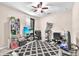 Bedroom featuring a ceiling fan, a geometric carpet, and shelves for storage and display at 11525 Scarlet Ibis Pl, Riverview, FL 33569