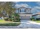 Charming two-story home featuring a spacious garage and beautifully landscaped front yard at 11525 Scarlet Ibis Pl, Riverview, FL 33569