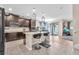Modern kitchen with dark cabinets, a center island with bar stools, and stylish pendant lighting at 11525 Scarlet Ibis Pl, Riverview, FL 33569