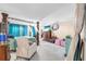 Spacious main bedroom featuring carpet flooring, a four-poster bed, and ample natural light at 11525 Scarlet Ibis Pl, Riverview, FL 33569
