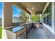 Gourmet outdoor kitchen has granite counters, built-in BBQ, and stainless steel appliances at 11525 Scarlet Ibis Pl, Riverview, FL 33569