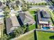 View from above of a backyard with a large grassy area, white fence, and mature trees at 11525 Scarlet Ibis Pl, Riverview, FL 33569