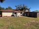 Spacious backyard showcasing the home's exterior and providing ample outdoor space at 11600 Crystal Lake Dr, Port Richey, FL 34668