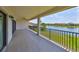 Long balcony with view of pond and surrounding houses at 11909 Climbing Fern Ave, Riverview, FL 33579