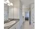 Clean bathroom features granite countertop, white cabinets, tile floors, and a shower with a curtain at 11909 Climbing Fern Ave, Riverview, FL 33579