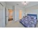 Comfortable bedroom has soft carpet, an elegant chandelier, and leads to the bathroom and closet at 11909 Climbing Fern Ave, Riverview, FL 33579