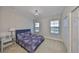 Cozy bedroom with lake views, light carpet, a chandelier, and a comfortable queen-sized bed at 11909 Climbing Fern Ave, Riverview, FL 33579