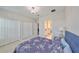 Bright bedroom features neutral walls, soft carpet, a chandelier, closet space, and access to the bathroom at 11909 Climbing Fern Ave, Riverview, FL 33579