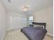 Charming bedroom features neutral walls, plush carpet, an elegant chandelier, and ample closet space at 11909 Climbing Fern Ave, Riverview, FL 33579