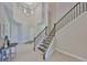 Grand foyer with high ceilings, staircase, and elegant chandelier, creating a welcoming entrance at 11909 Climbing Fern Ave, Riverview, FL 33579