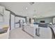 Spacious kitchen with white cabinets, stainless steel appliances, and an island overlooking the living area at 11909 Climbing Fern Ave, Riverview, FL 33579