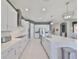 Well-appointed kitchen with white cabinets, stainless appliances, and large center island for entertaining at 11909 Climbing Fern Ave, Riverview, FL 33579